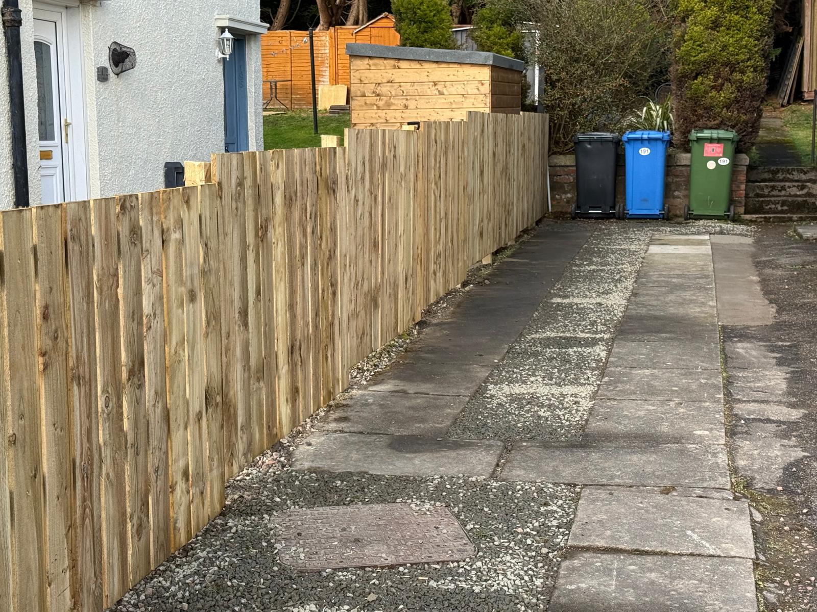 New close-board timber fence installed along side path