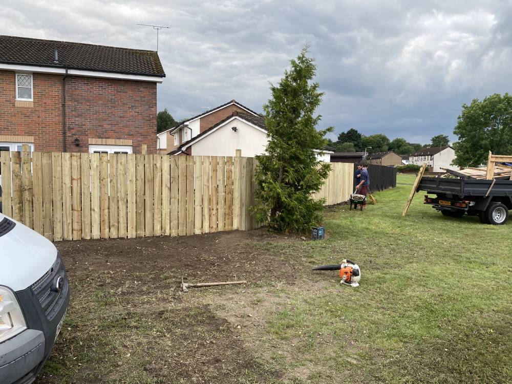 Close-board timber fence installation