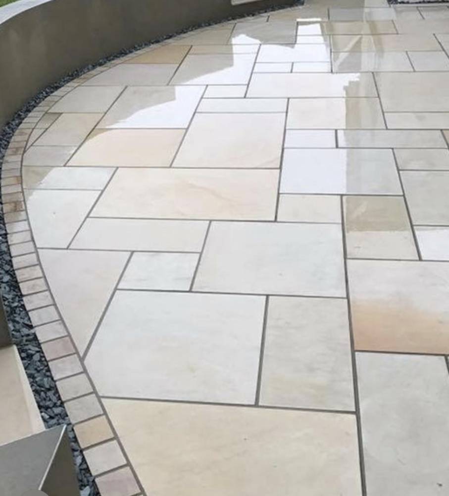 Curved sandstone patio with gravel border