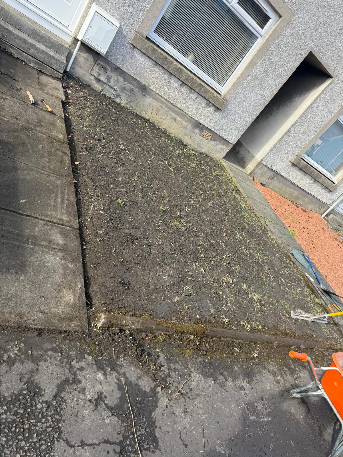 Front garden before gravel installation showing bare soil