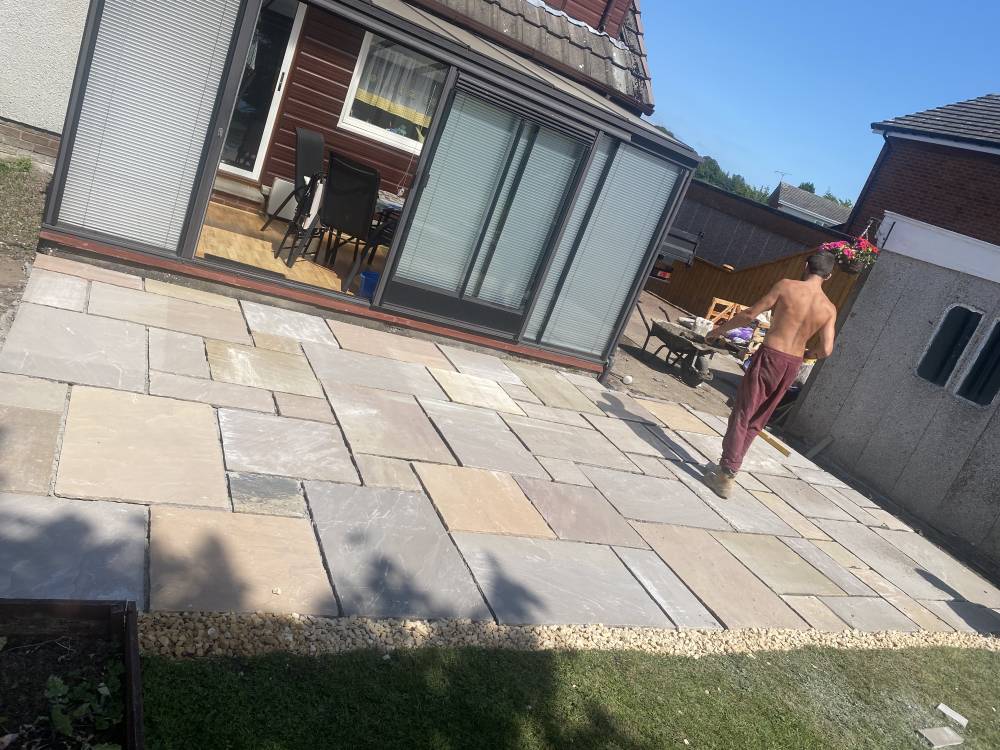 Completed Indian sandstone patio with gravel edging in Stirling