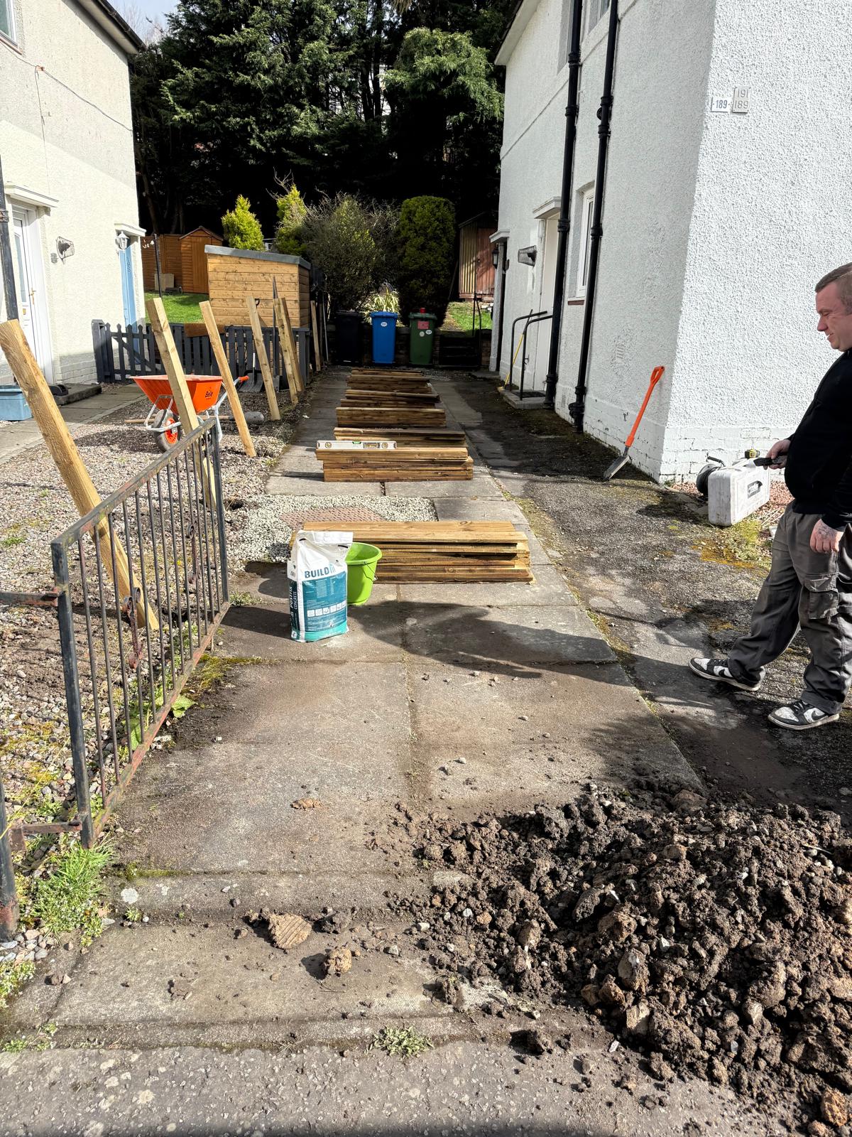Fence posts and timber laid out during side path fencing project