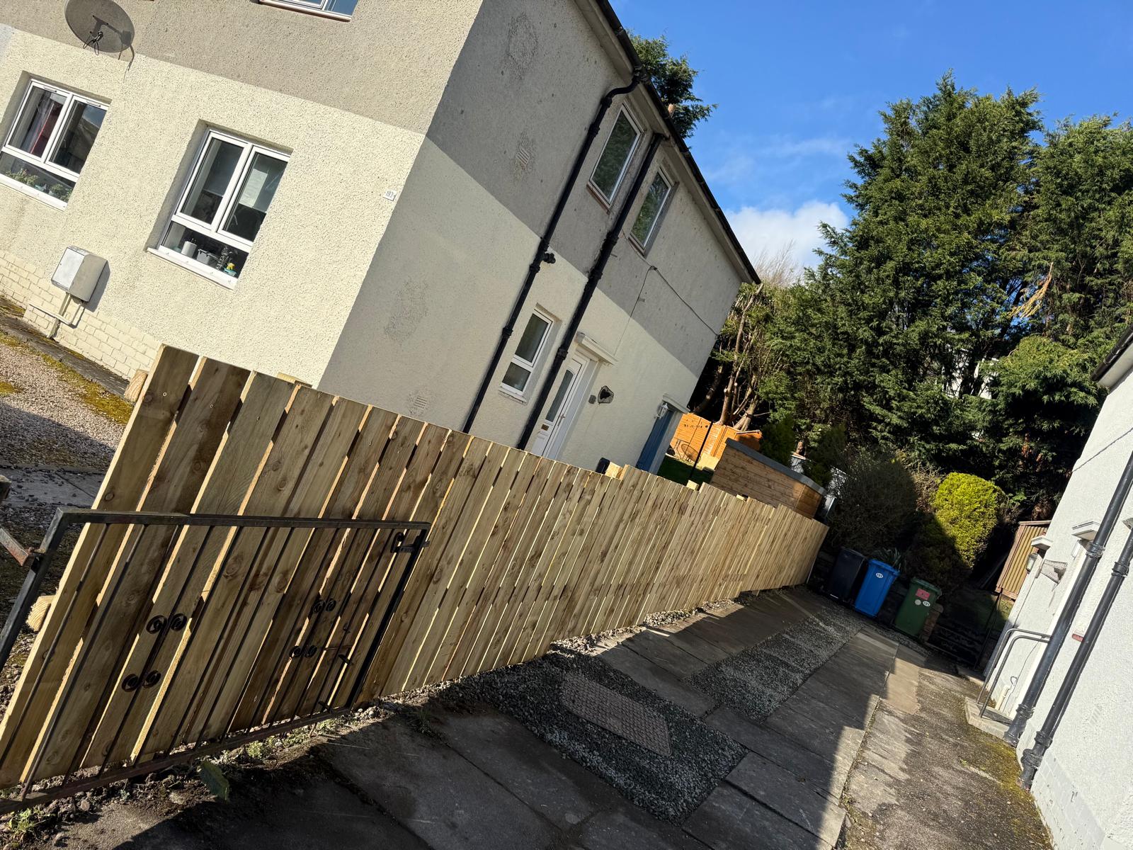 Side path fencing project completed with gate and gravel