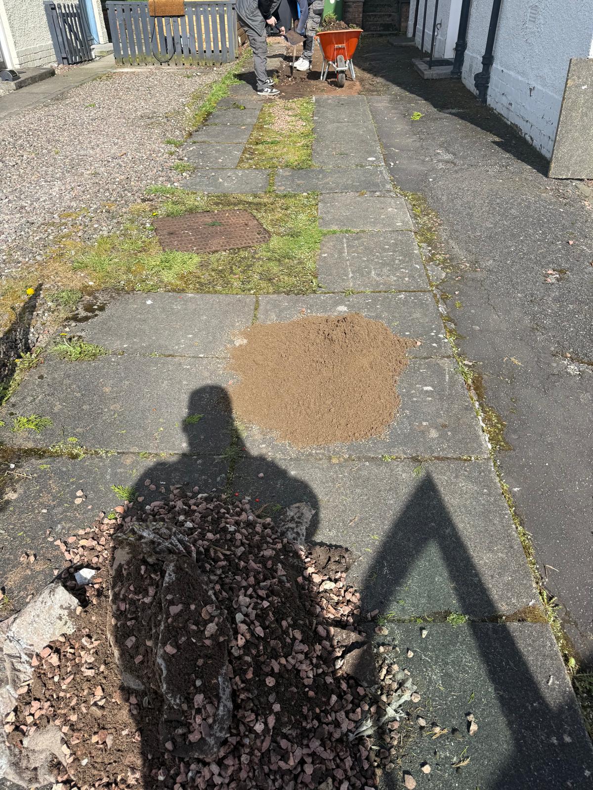Side path before clearance showing old paving and moss