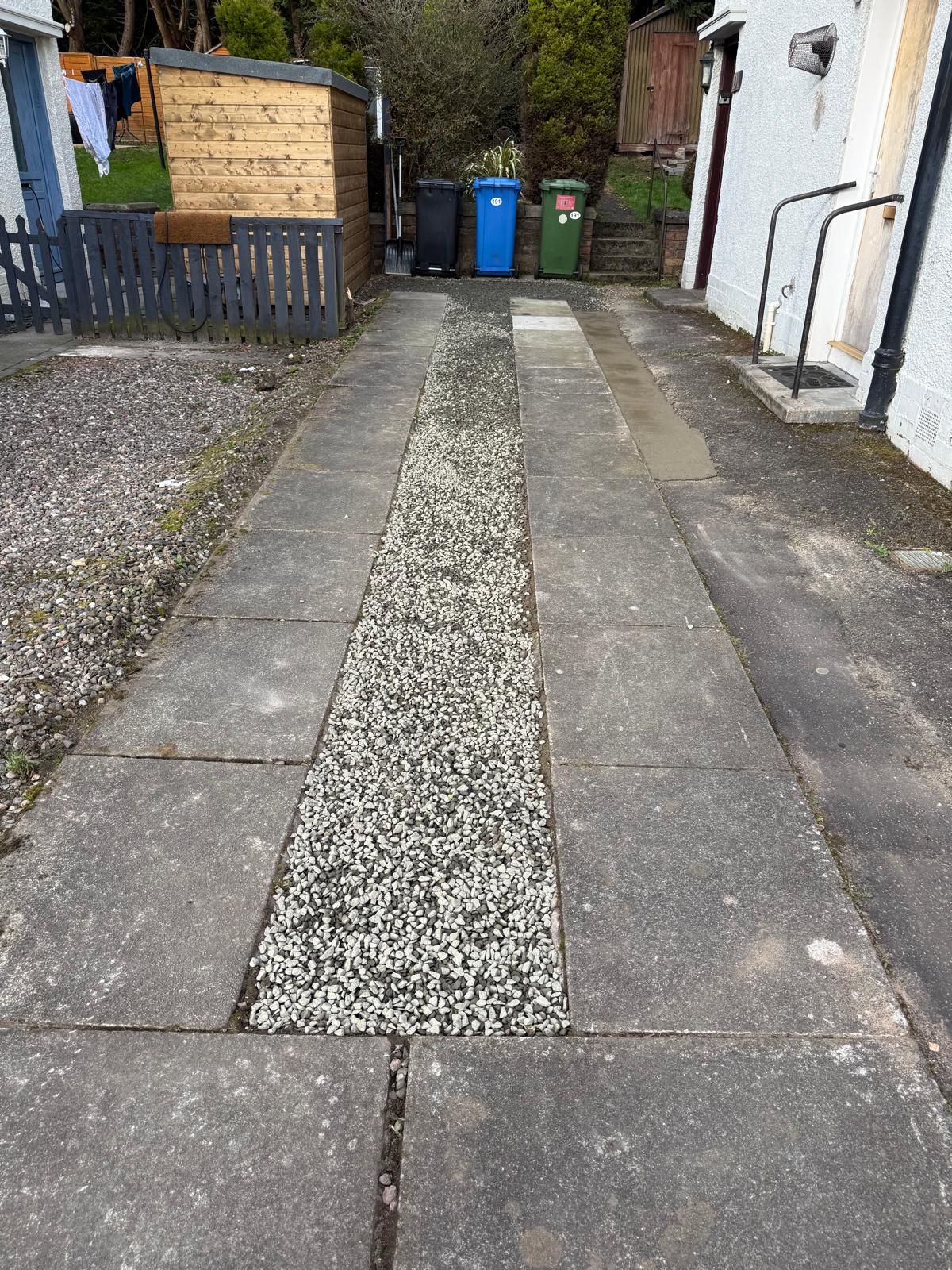Side path with new gravel infill between paving slabs